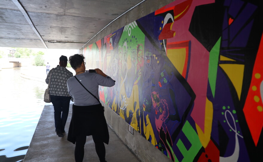 Visitors viewing the installed mural.